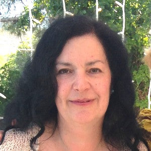 Person with long dark hair in an outdoor setting